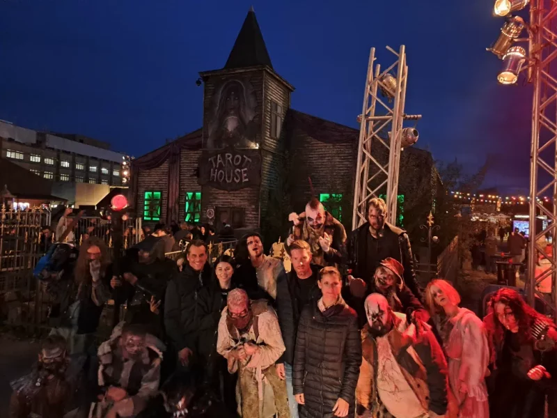 a group of people in clothing outside of a building